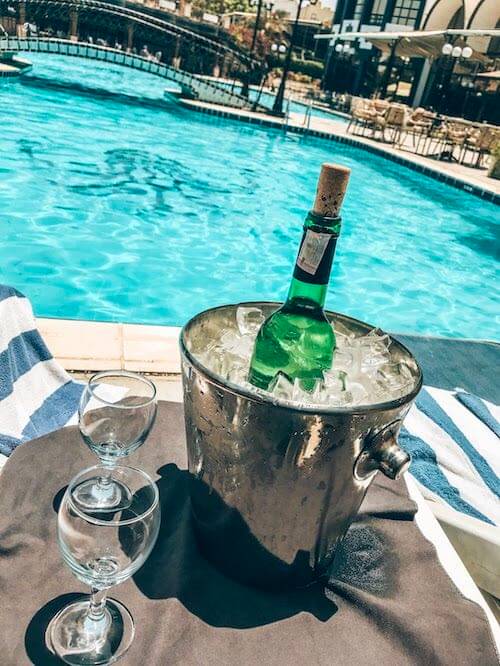 backpacker - wine bottle in icebucket by pool in egypt