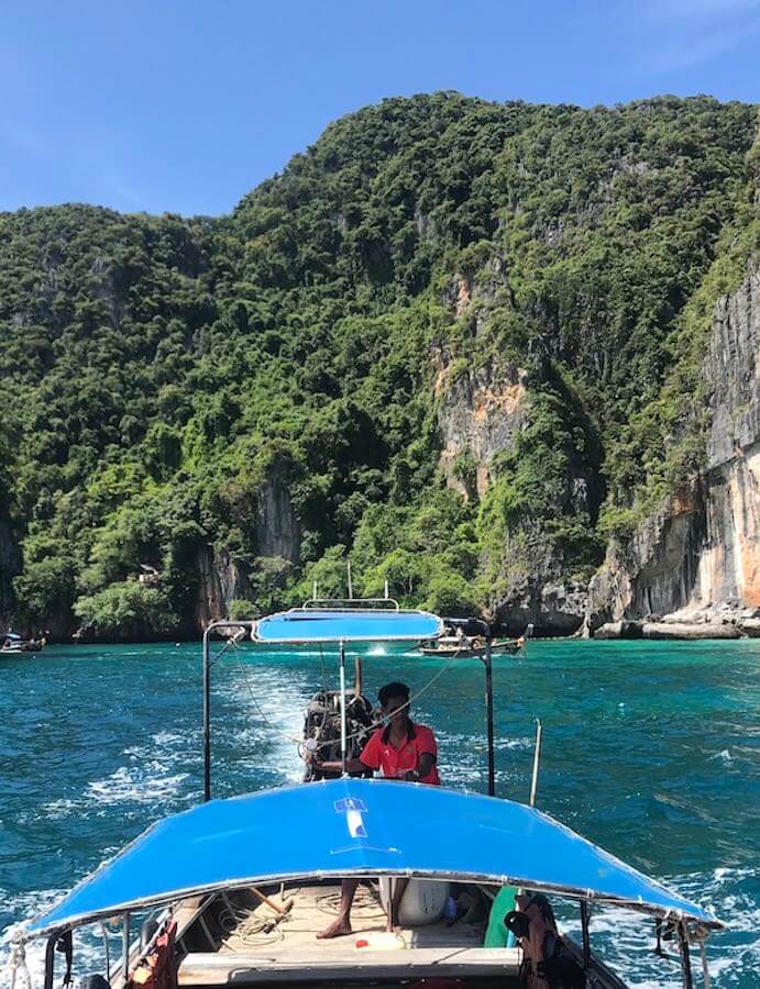 backpacker - guy driving boat privately hired in koh phi phi islands