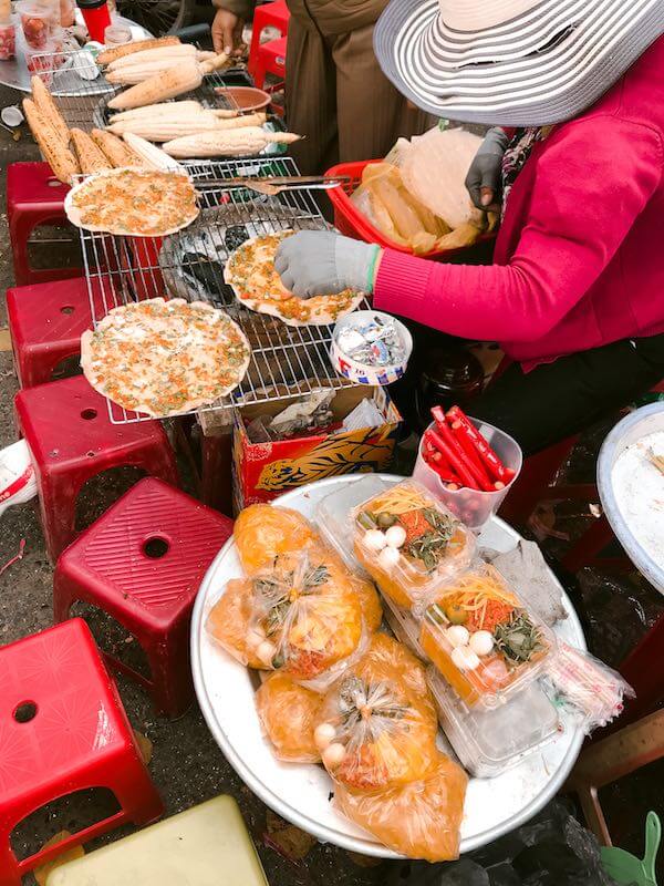 backpacker - ladies cooking street food in vietnam
