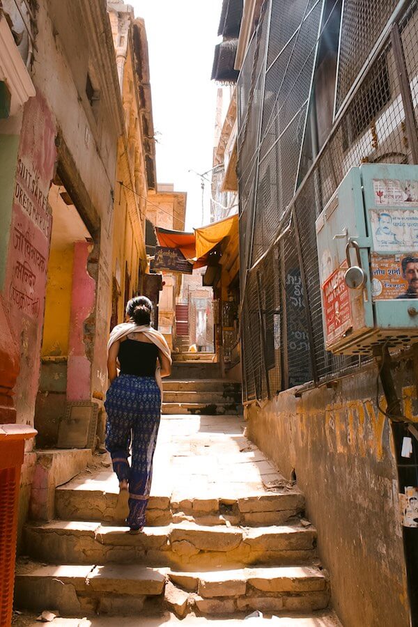 backpacker - girl walking in the streets of Varanasi