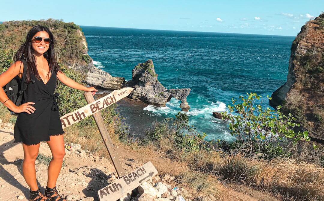 solo travel - girl standing over looking ocean in nusa penida