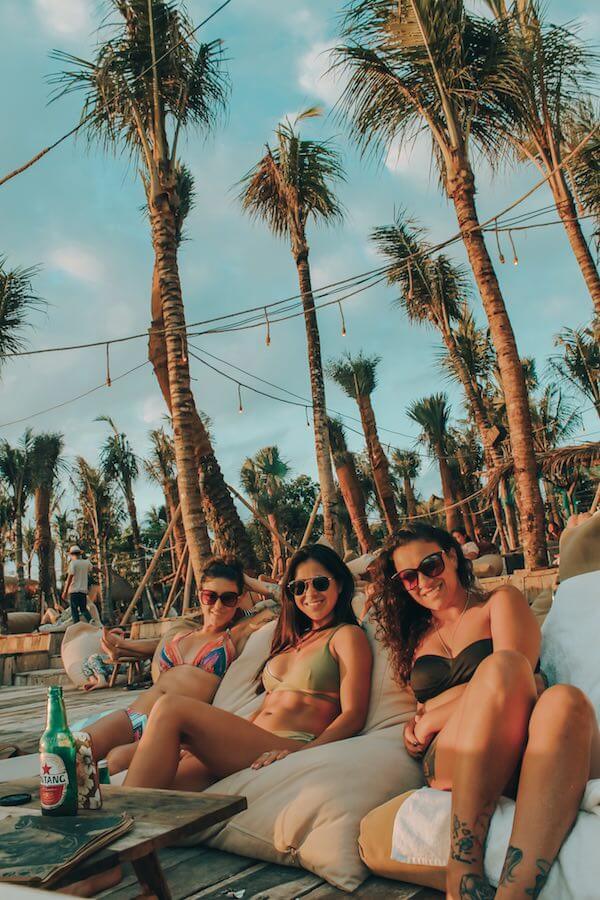 solo travel - 3 girls sitting together in canggu sitting in beanbag chairs