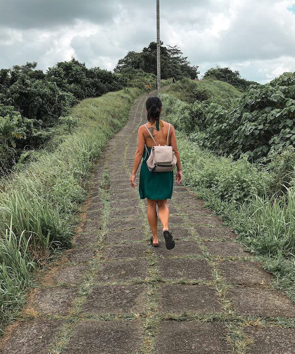solo travel - girl walking in ubud on path through jungle
