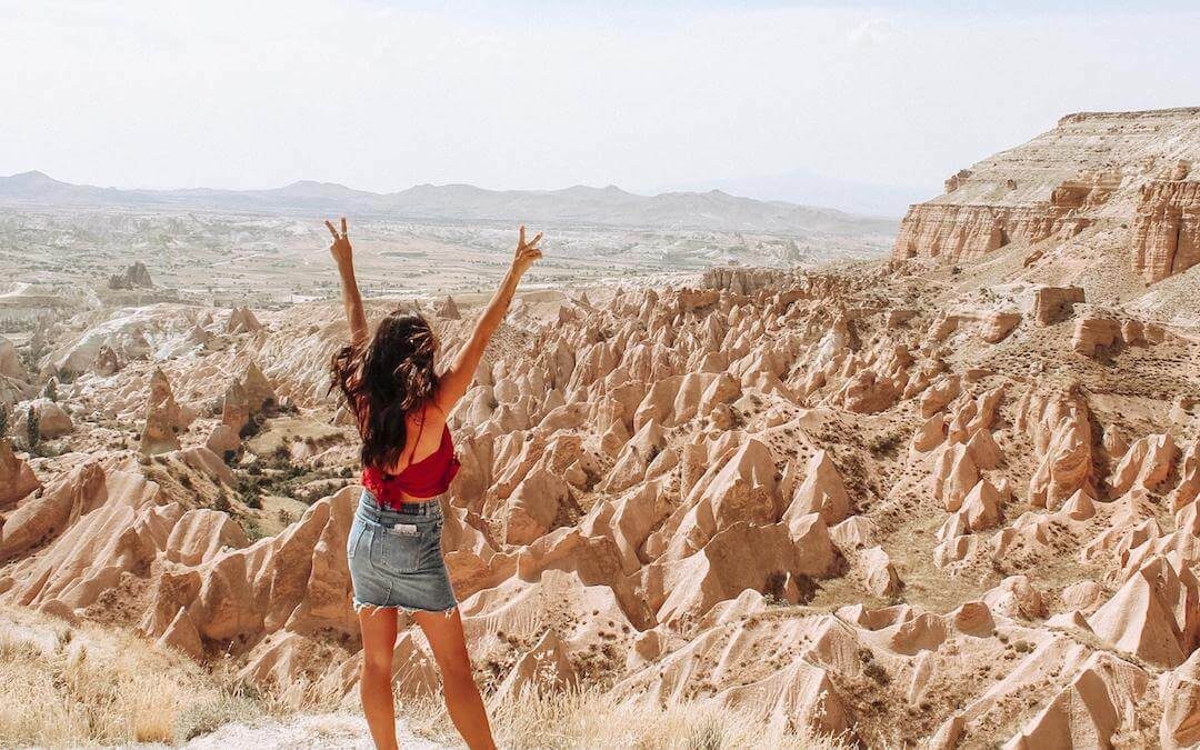 travel the world - girl posing in front of the love valley in cappadocia turkey