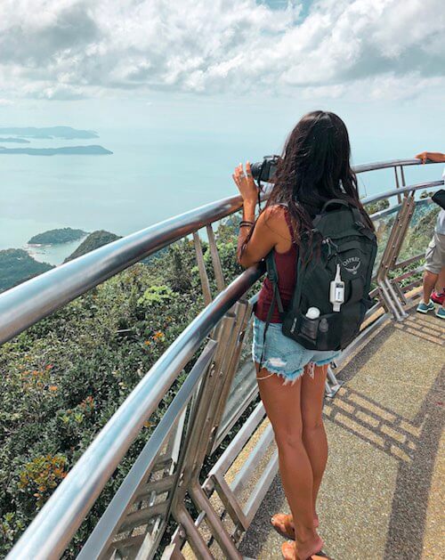 travel the world - girl taking a photo overlooking the ocean in Langkawi