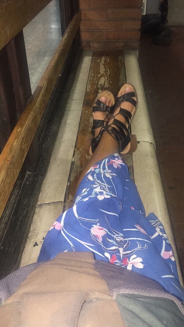 plan solo trip - girl sitting in windowsill of bus stop in italy
