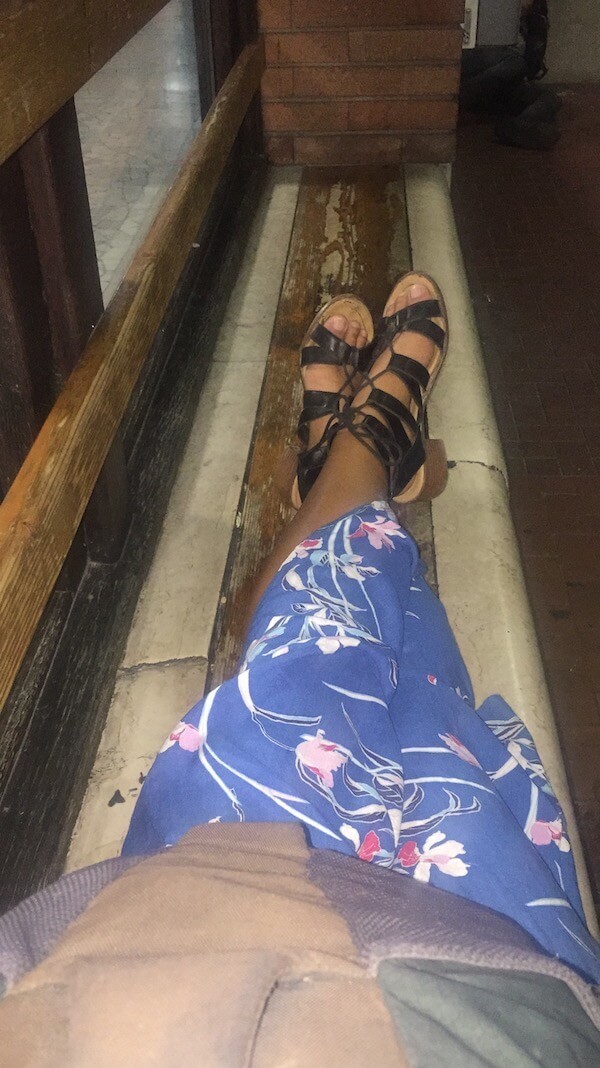 plan solo trip - girl sitting in windowsill of bus stop in italy