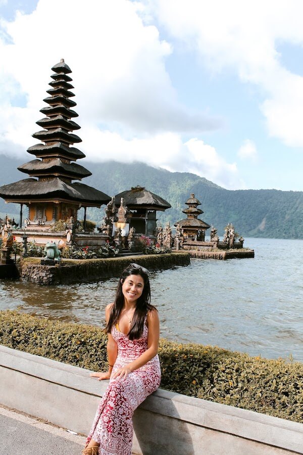 girl sitting in front of temple in bali