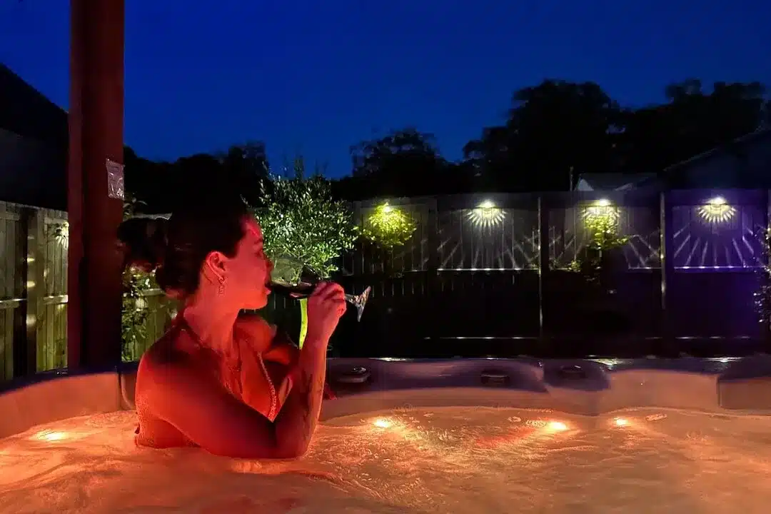 Enjoying a glass of wine in the private hot tub at Lorraines Loft