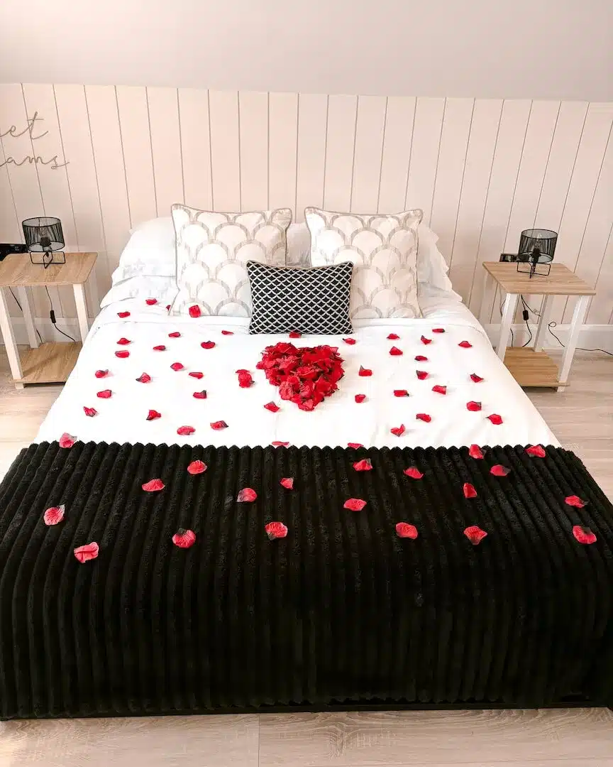 rose petals on the bed for the romance package at Lorraine's Loft, a romantic getaway in Northern Ireland